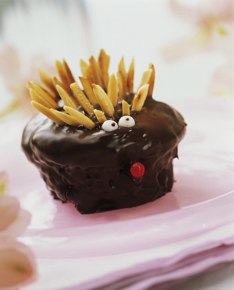 Hedgehog muffins with chocolate icing and almond slivers