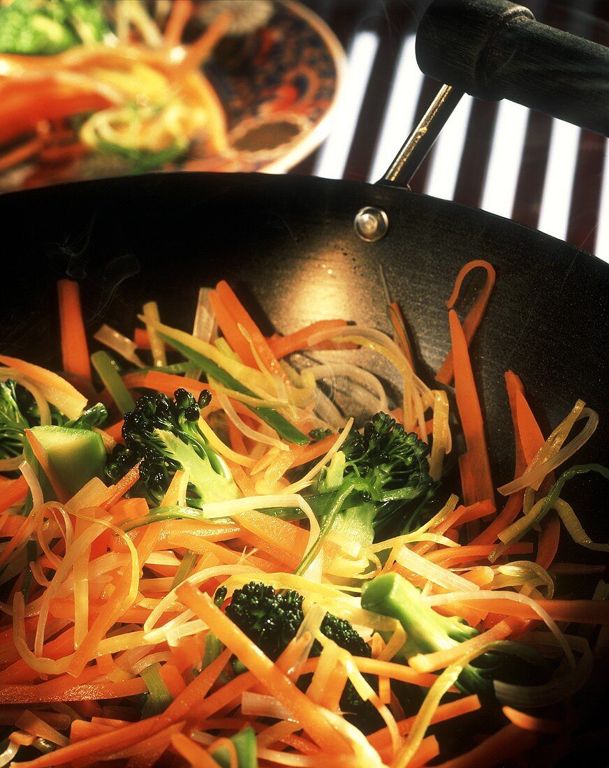 Vegetable trio: carrots, leeks, and broccoli in wok