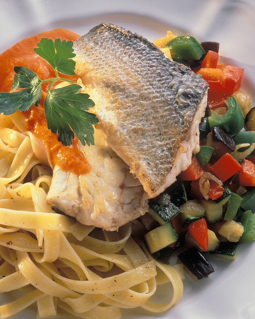 Baked Sea Bass on a Bed of Fettucine and Vegetables