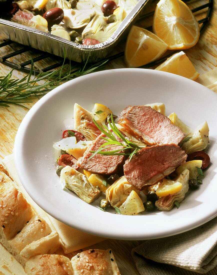 Lamb with lemon, artichokes & tarragon on plate