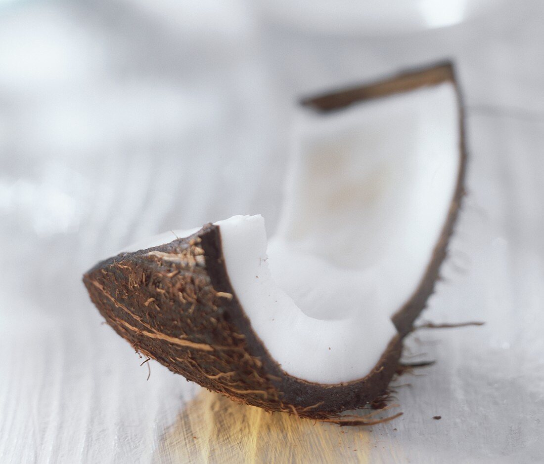 Two coconut wedges on a light background