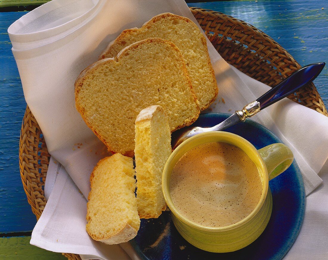 White sandwich loaf in bread basket with coffee cup