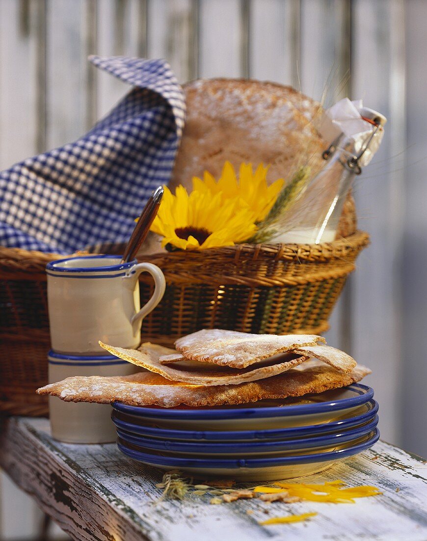 Finnish barley flat bread on pile of plates & in basket