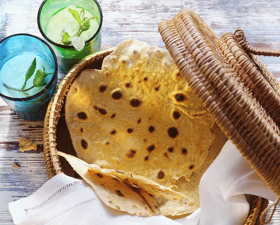 Indian chapatis in a basket; mint drink