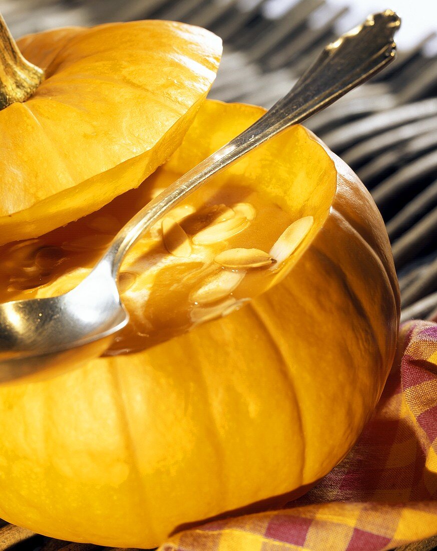 Pumpkin cream soup with flaked almonds in pumpkin