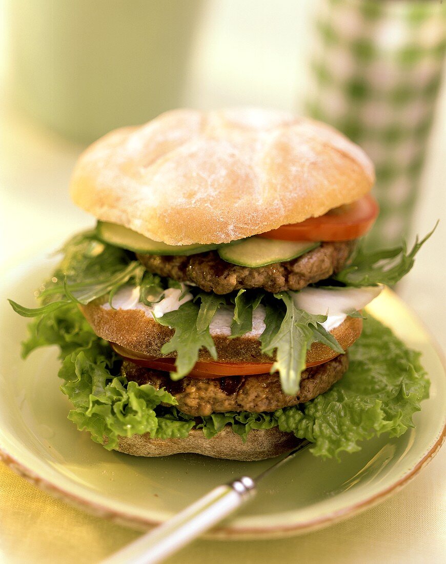 Double-decker: burger with two burgers, tomatoes, rocket
