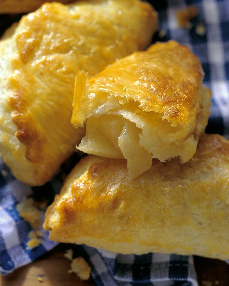 Apple turnovers from quark puff pastry, one cut into