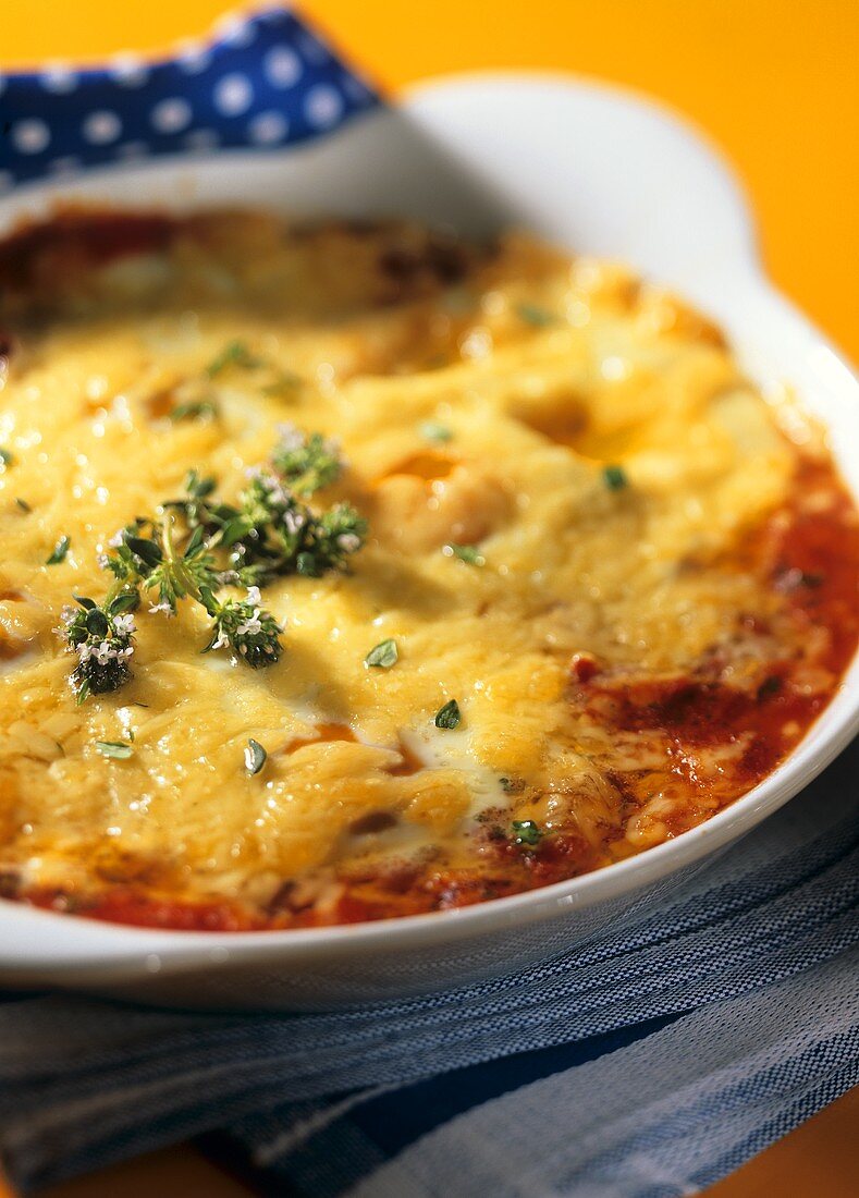 Spanish eggs with tomatoes and herbs in gratin dish