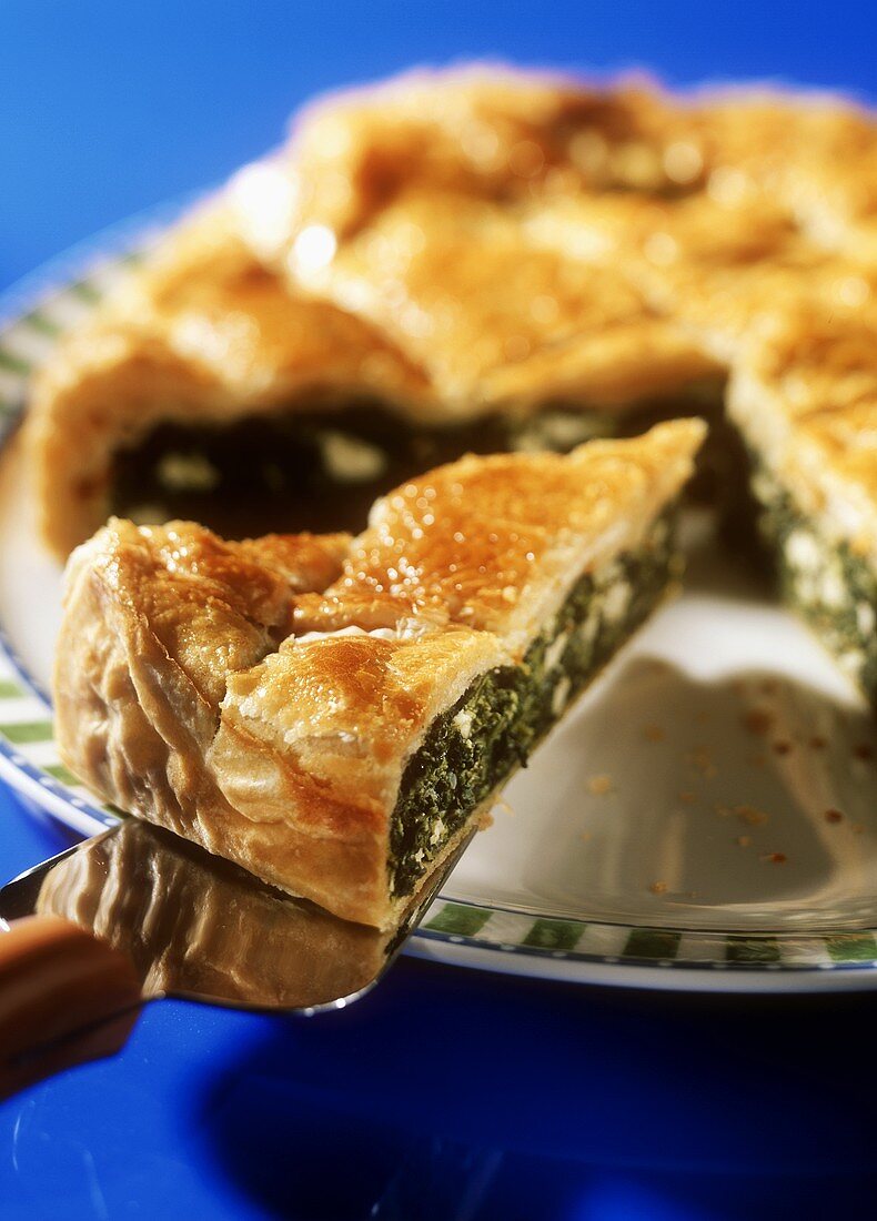 Greek spinach pie on server and plate