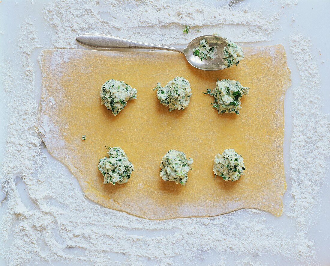 Rolled-out pasta dough with blobs of … – License Images – 217710 StockFood