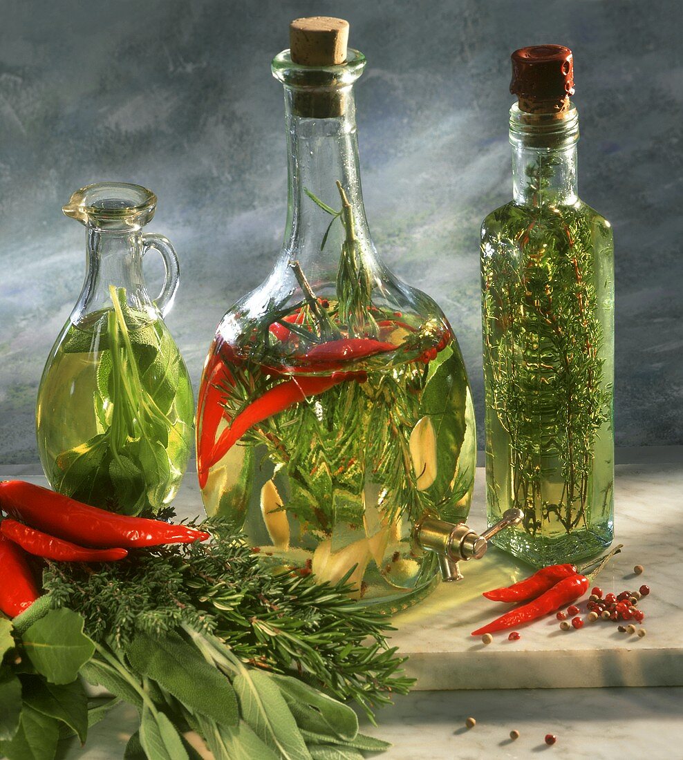 Three bottles of herb vinegar with sage, rosemary & thyme