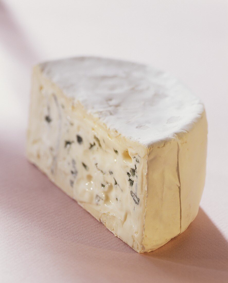 Blue cheese, piece cut, on light background
