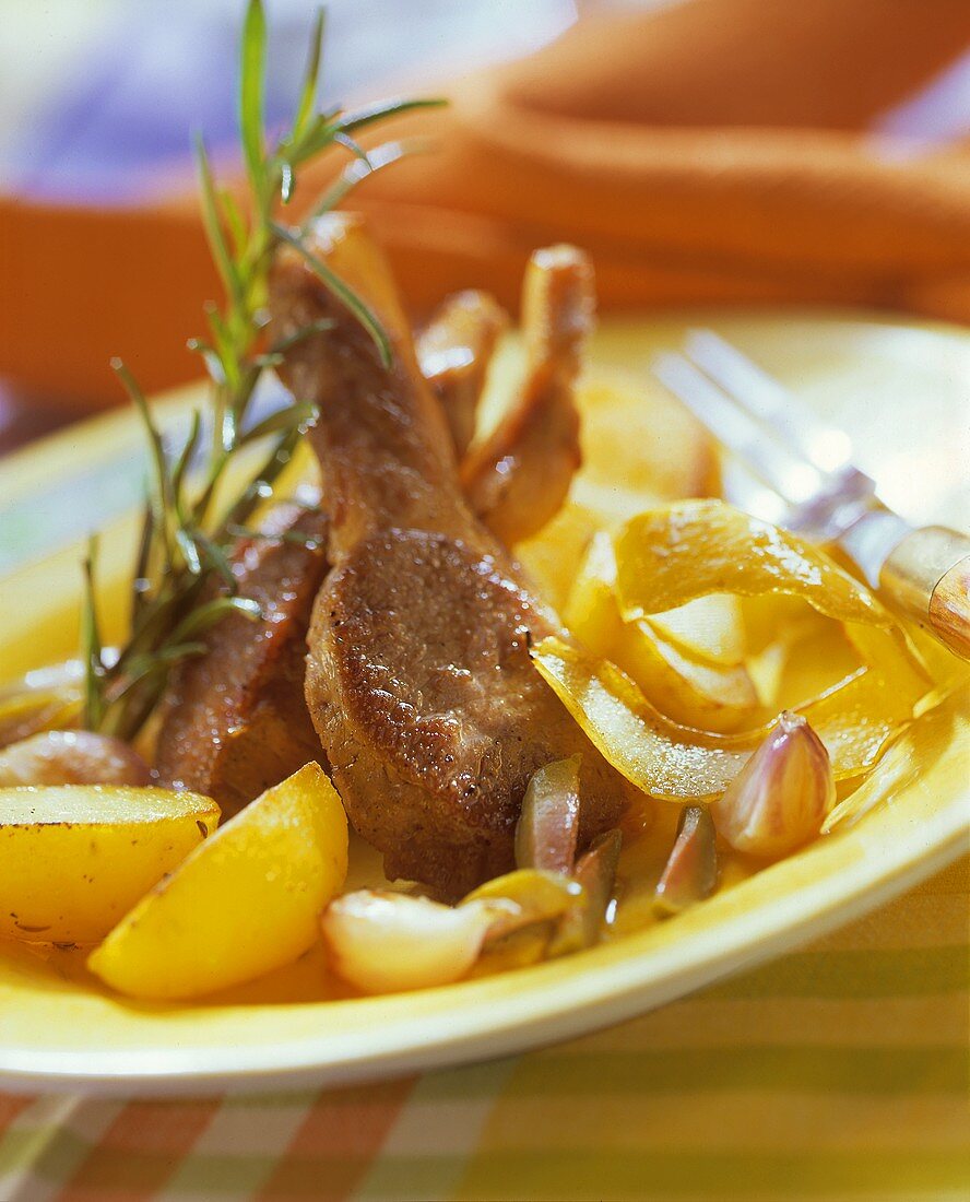 Marinated lamb cutlets with potatoes and rosemary sprig