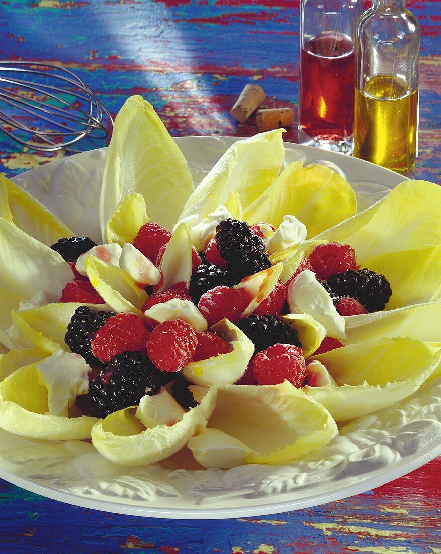 Chicory salad with berries and cream cheese on plate
