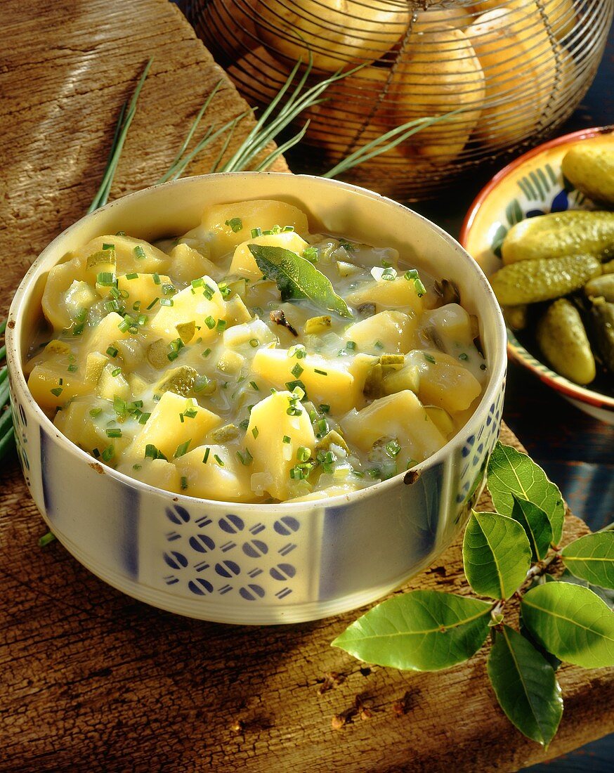 Sour potato casserole with gherkins, chives, bay leaf