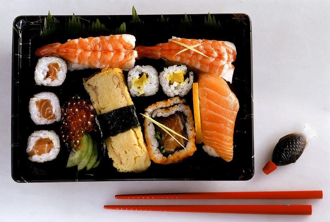 Various sushi and maki in a plastic bowl