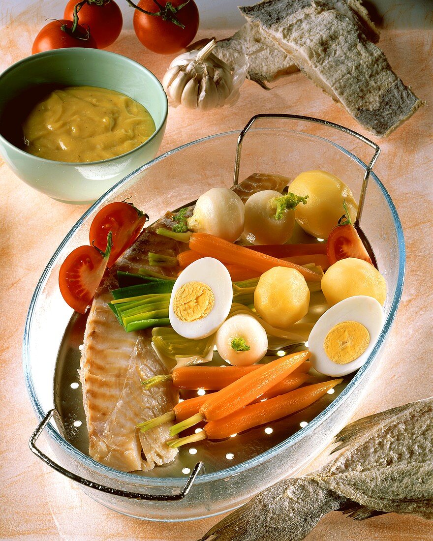 Gedämpfter Stockfisch mit Gemüse und gekochten Eiern; Aioli