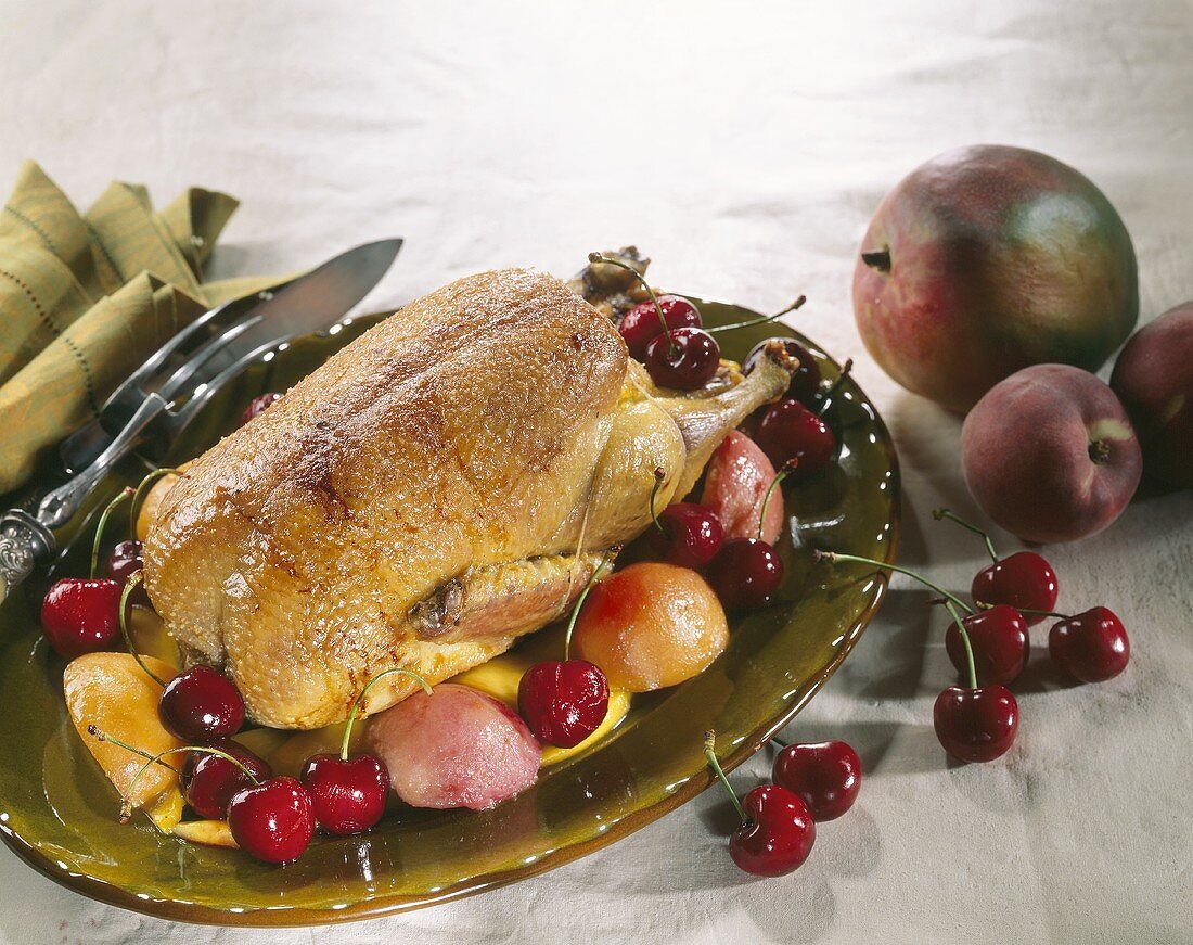 Roast duck with peach, mango and cherries