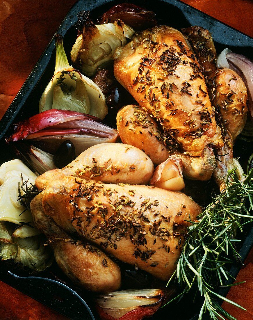 Roast poussin with fennel seeds & vegetables in roasting tin
