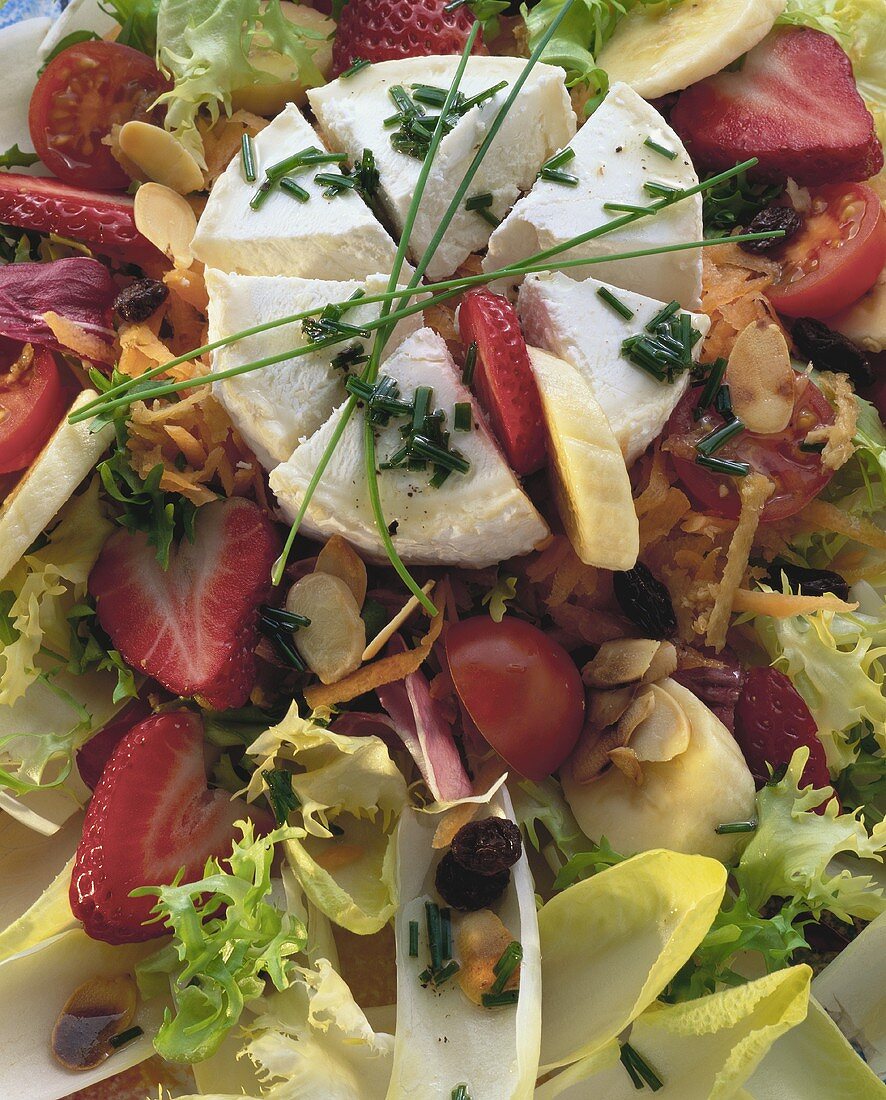 Salad leaves with goat's cheese and fruit (filling the picture)