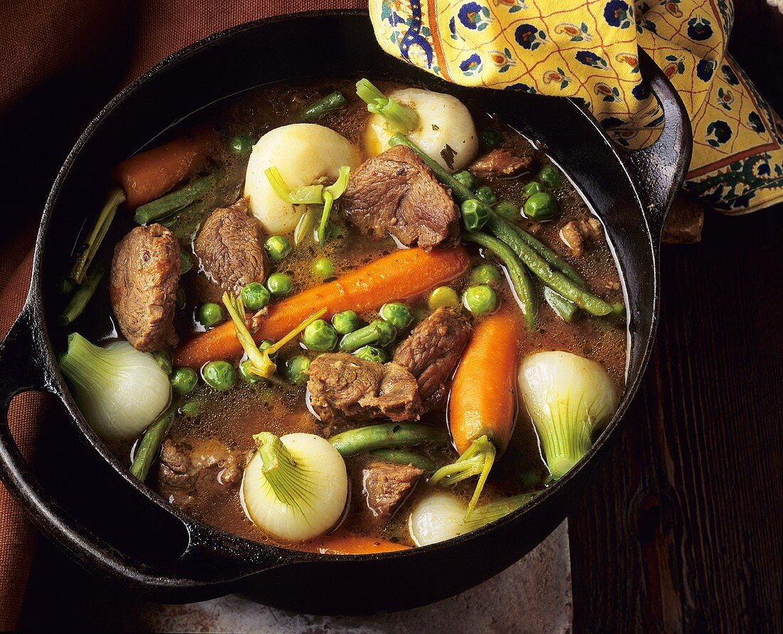 Beef stew with vegetables in cast-iron pan