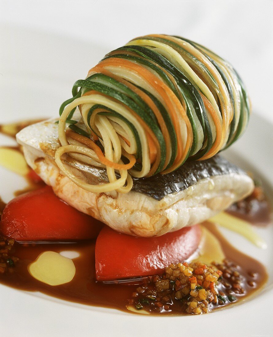 Bream with vegetable noodles on plate