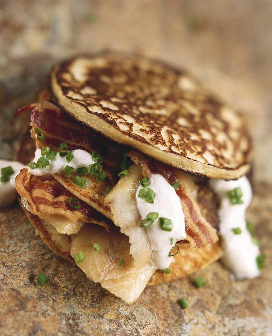 Trout and bacon pancakes with sour cream and chives