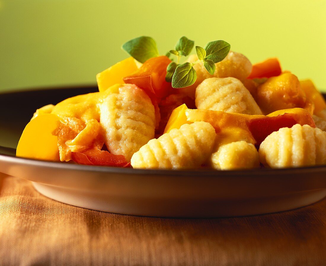 Gnocchi with pumpkin and peppers on plate