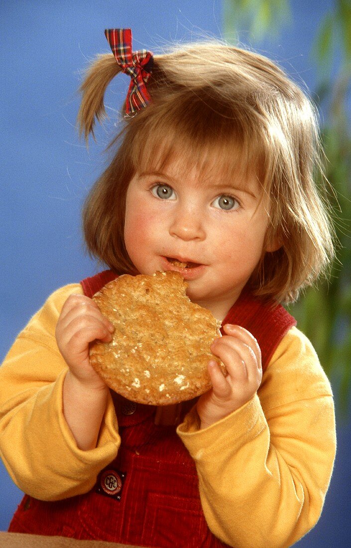 Small girl eating a flat bread