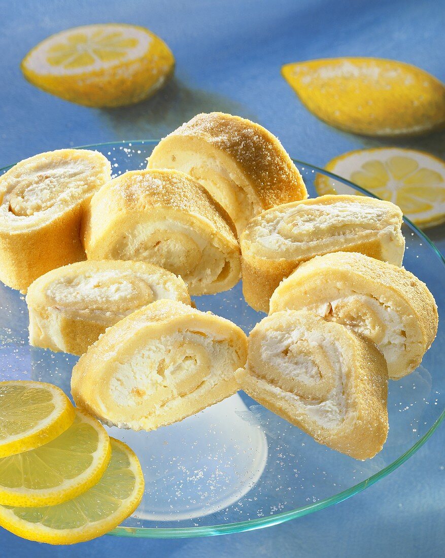 Lemon sponge rolls on a glass plate 