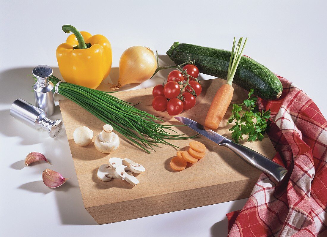 Still life with vegetables, mushrooms, chives on chopping board