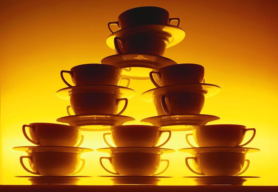 Pile of soup plates with yellow lighting