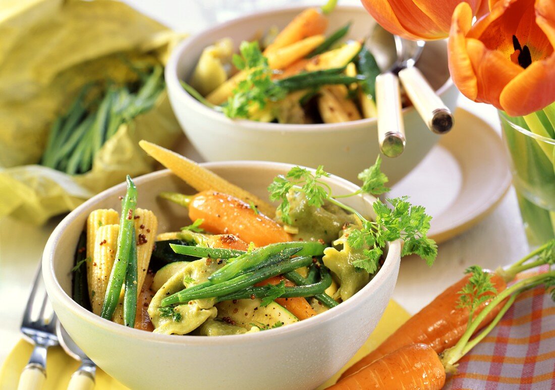 Primavera vegetables with tortellini in two bowls