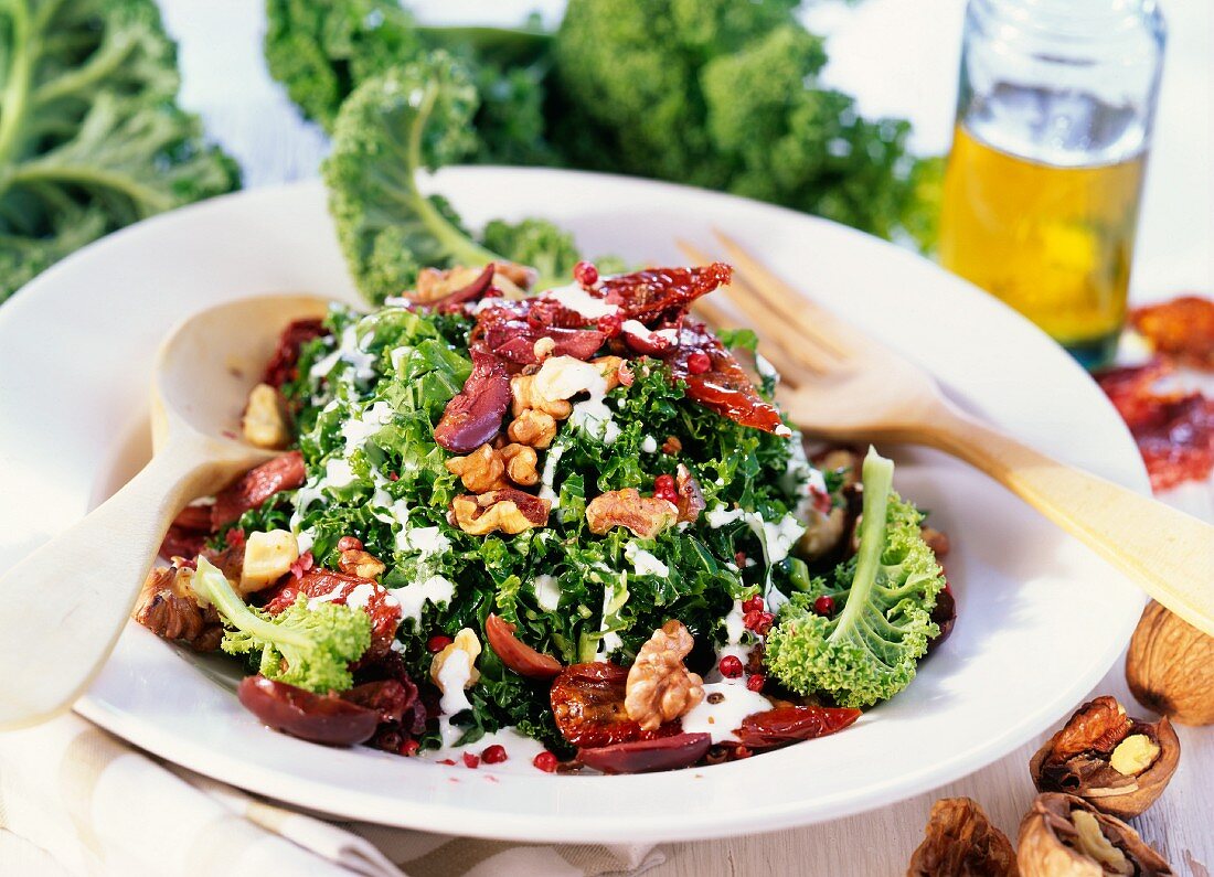 Kale salad with olives, nuts and dried tomatoes