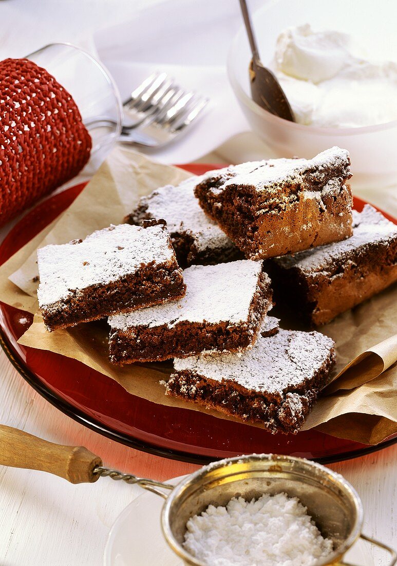 Chocolate cake, cut into rectangles, with icing sugar