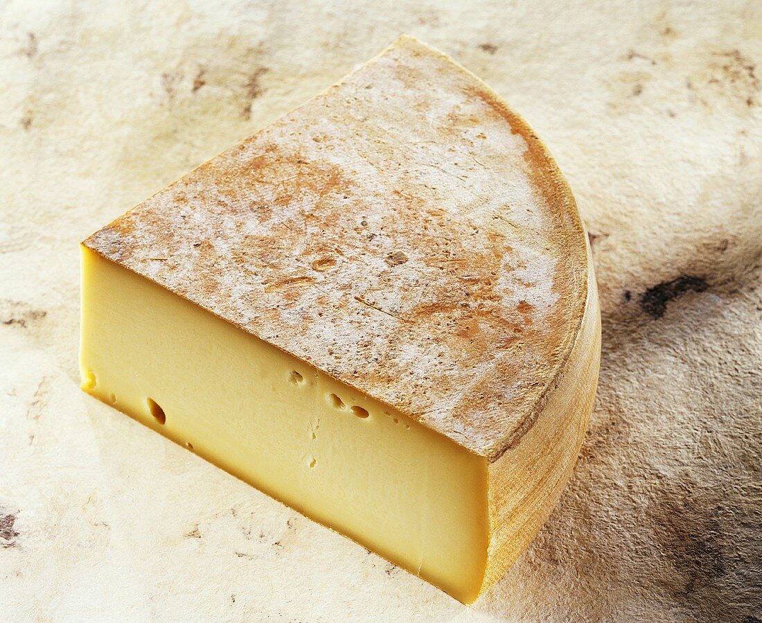 French Fromage a Raclette on light brown background