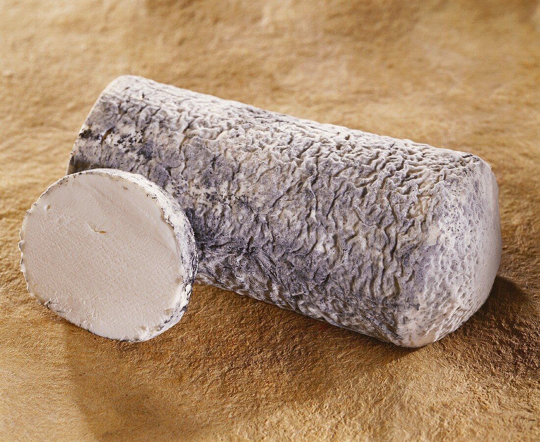 Le Joug, a French goat's cheese, on a brown background