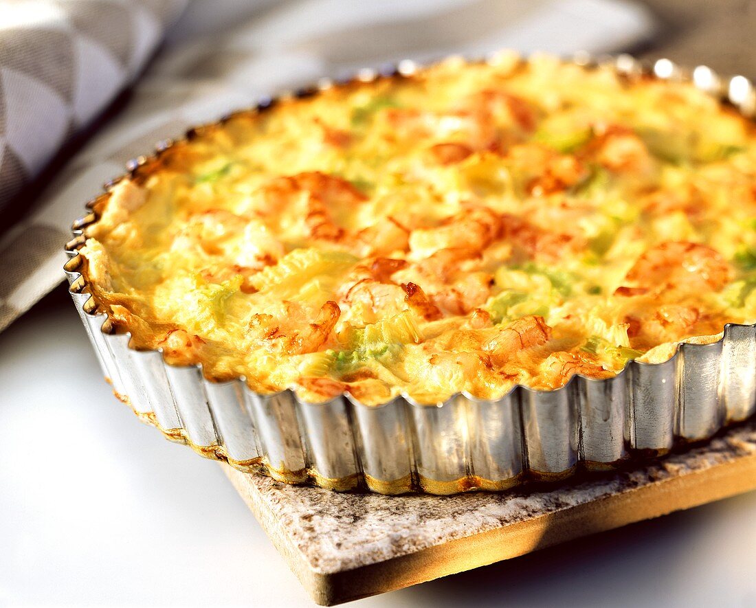 Quiche with celery and shrimps in the baking dish