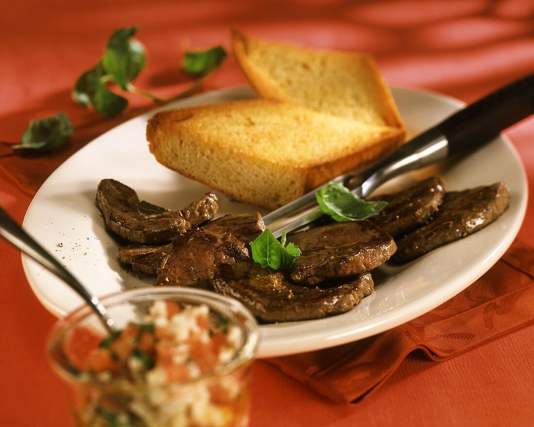 Barbecued beef fillets with garlic baguette & tomato pesto