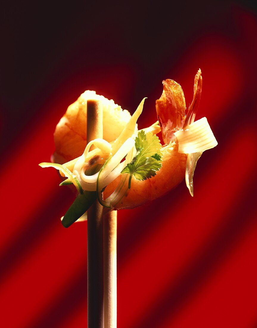 Scampi and vegetables on chopsticks