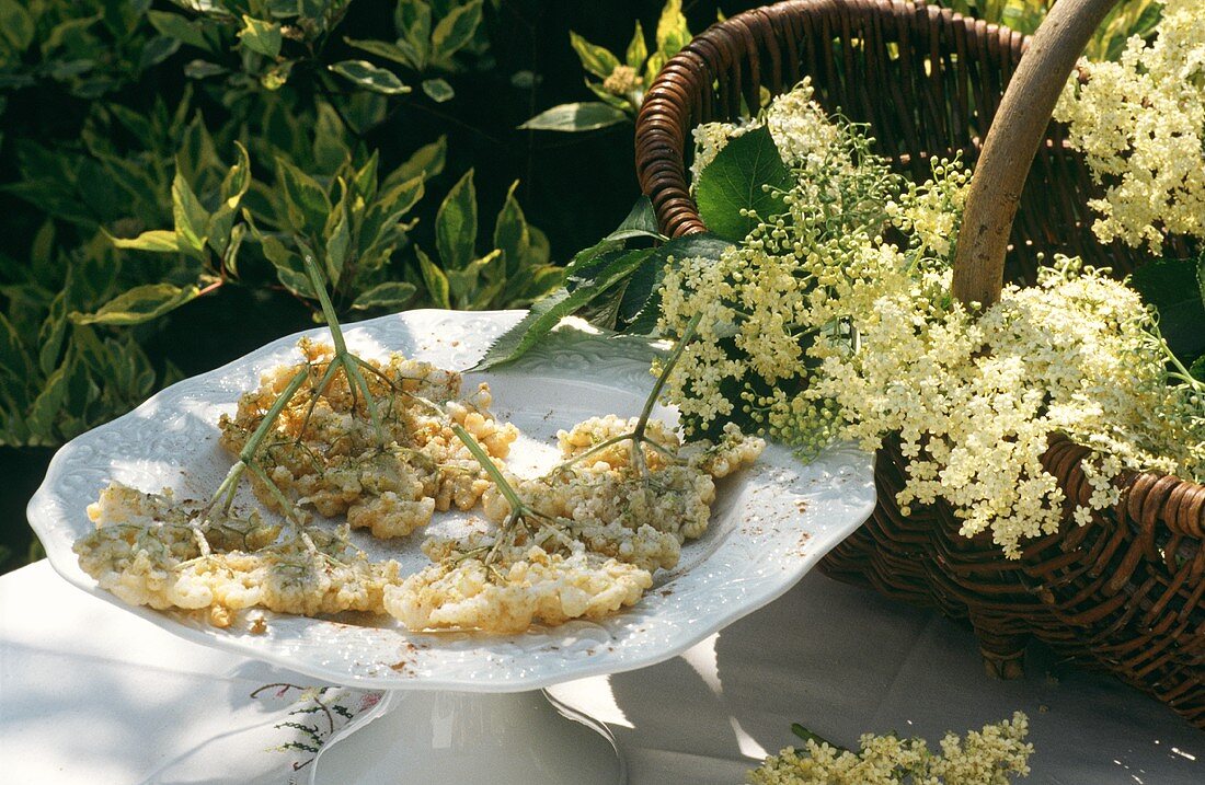 Elderflower fritters on white plate in open air