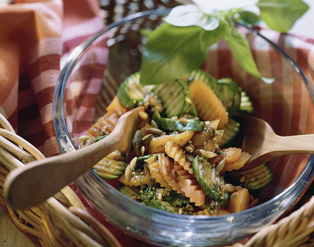 Courgette and carrot salad with pumpkin seeds in glass dish