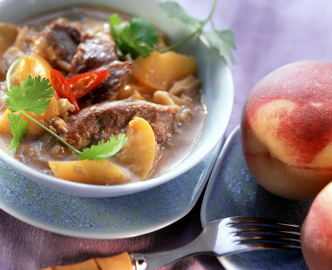 Duck curry with honey and peaches in sauce