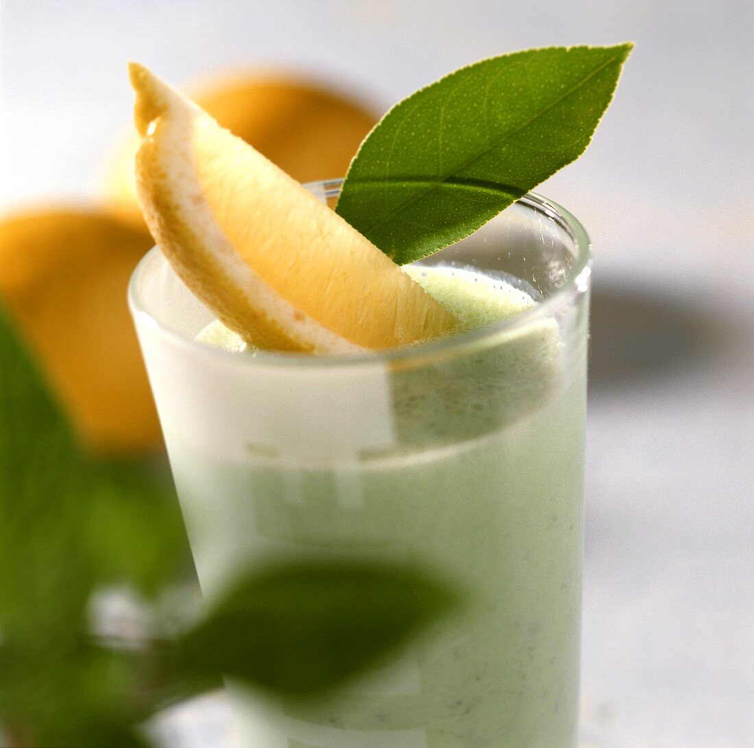 Sorrel flip with lemon wedge in glass