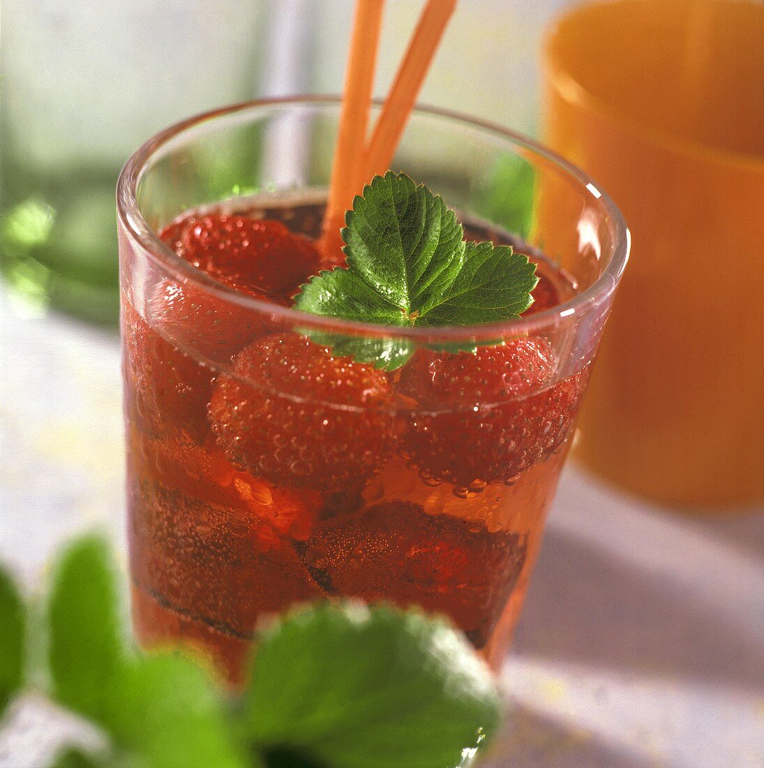 Strawberry punch with strawberry leaf in a glass
