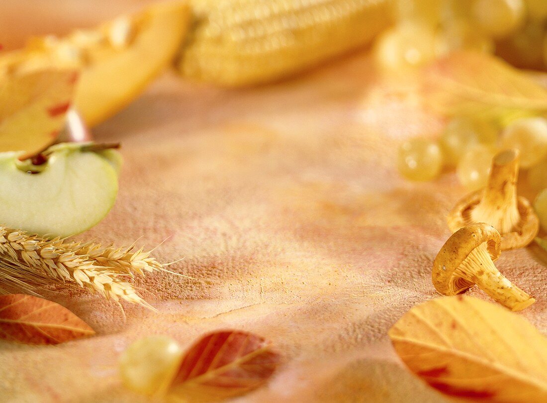 Still life with apple, ears of corn, mushrooms & autumn leaves