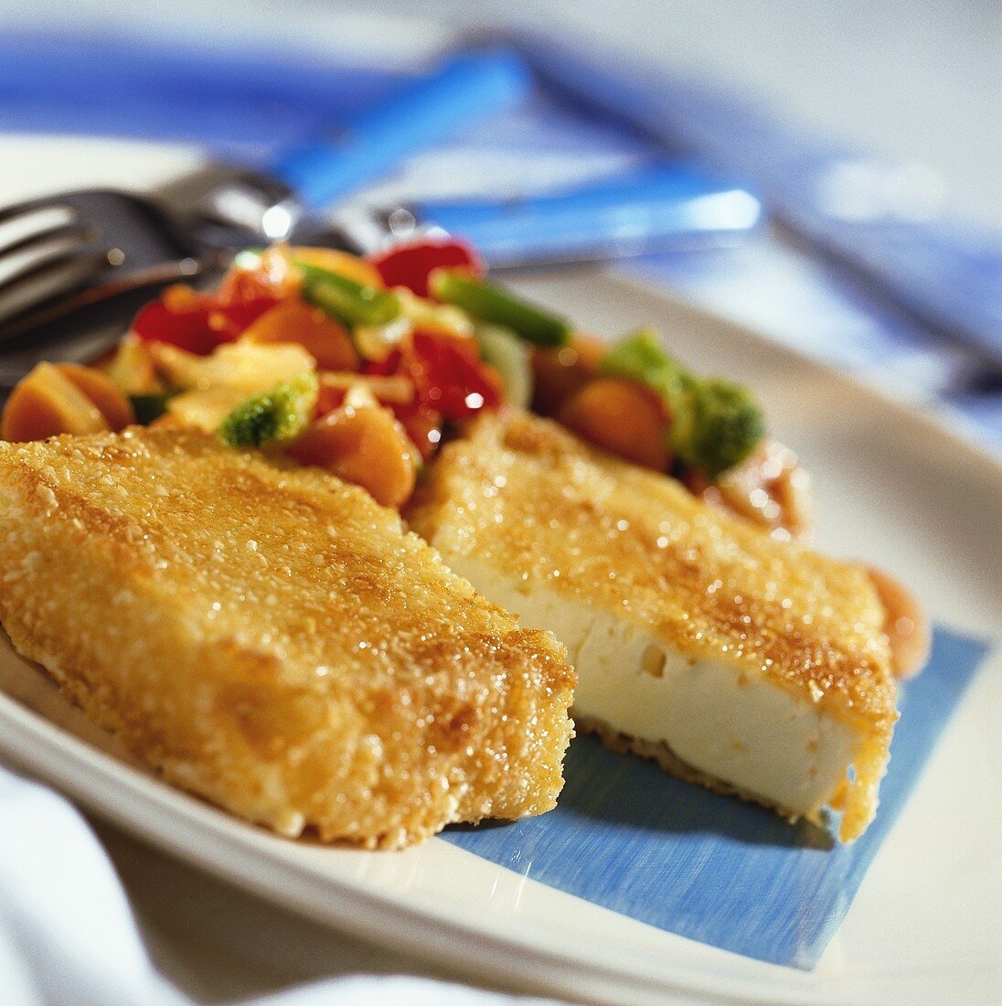 Breaded sheep's cheese with stir-fried vegetables
