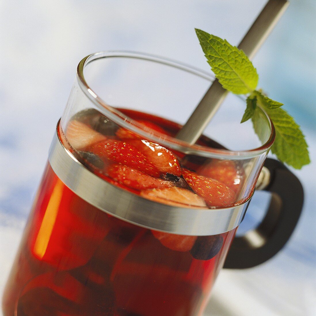 Vitamin-rich berry punch in glass with mint leaves