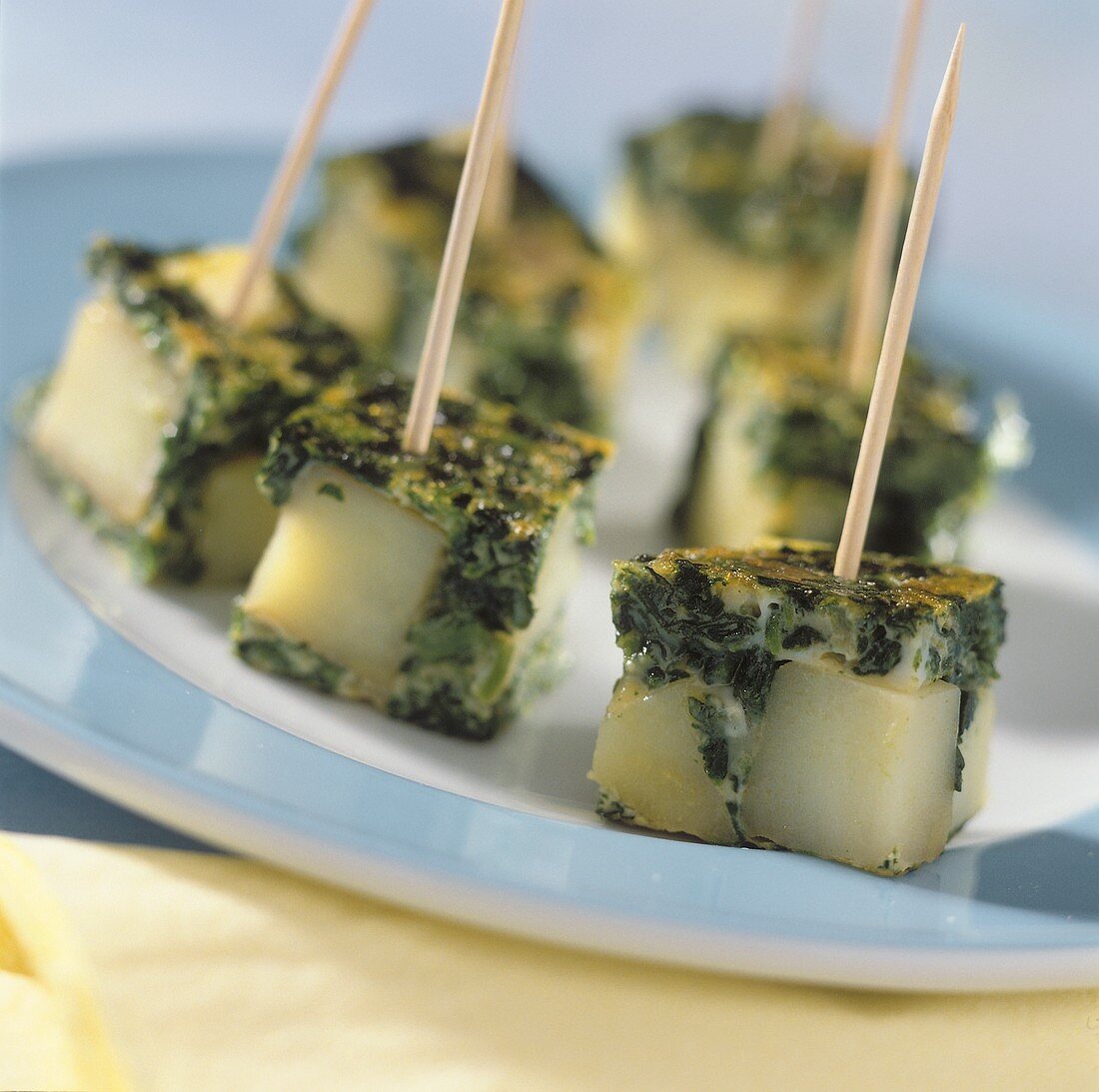 Spinach and tortilla cubes on toothpicks