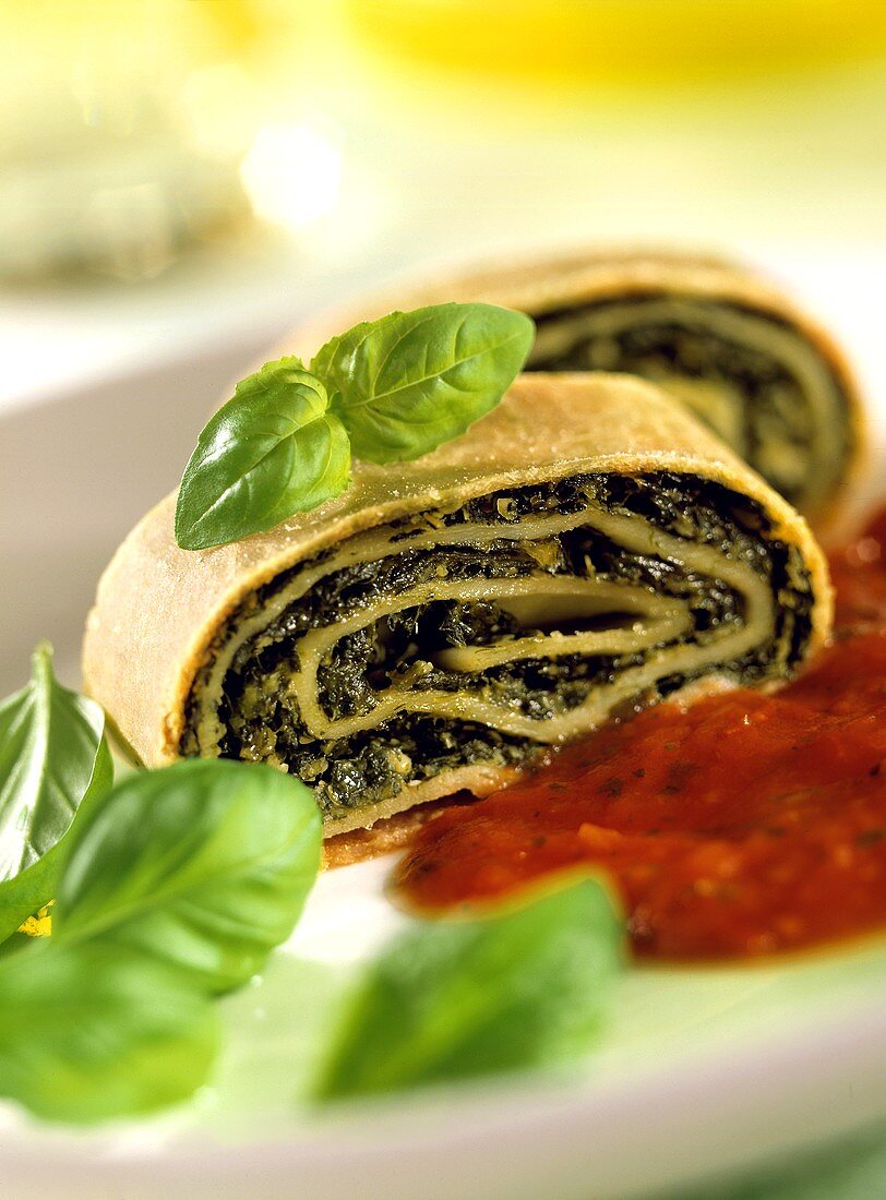 Spinach strudel with tomato sauce and basil